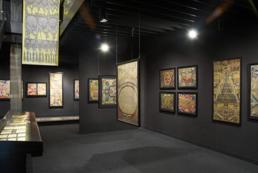 Ein Raum im Museum Art Brut in Lausanne. An den Wänden hängen mehrere Bilder.